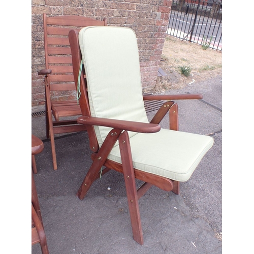 19 - A SET OF SIX TEAK GARDEN ARMCHAIRS folding, with seat pads (all in fair order, two slightly more wea... 