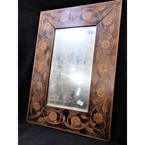 866 - AN EDWARDIAN PENWORK FRAMED MIRROR with bevelled plate 37 x 52cm