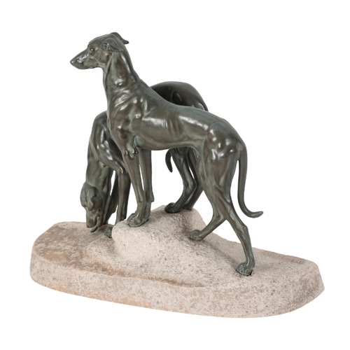 126 - AFTER JULES EDMOND MASSON (1871-1932) A pair of greyhounds mounted on a naturalistic sandstone base,... 