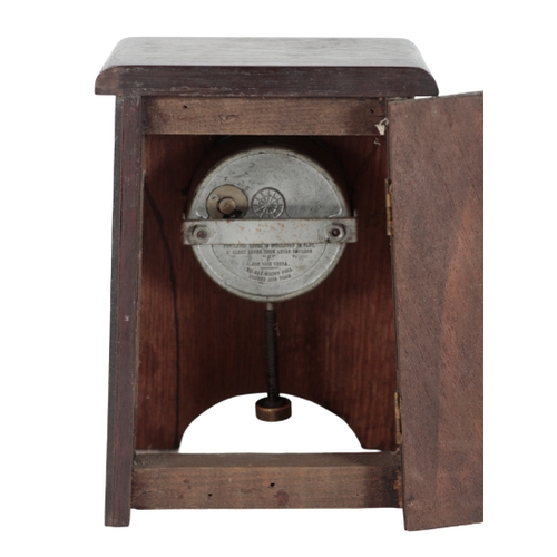 135 - A SMITH'S EIGHT-DAY CAR CLOCK with black dial and white Arabic numerals, housed in an Arts and Craft... 