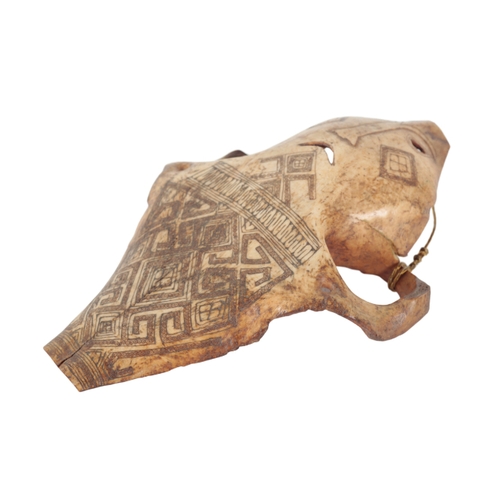 252 - A PAPUA NEW GUINEA CARVED BONE MASK engraved with geometric patternation, pierced to both sides, 26c... 