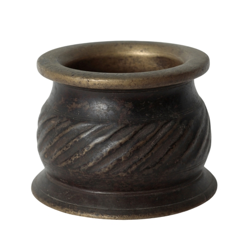 258 - A 16TH CENTURY HISPANO-MOORESQUE BRONZE PESTLE AND MORTAR the mortar with an out-turned rim, flatten... 