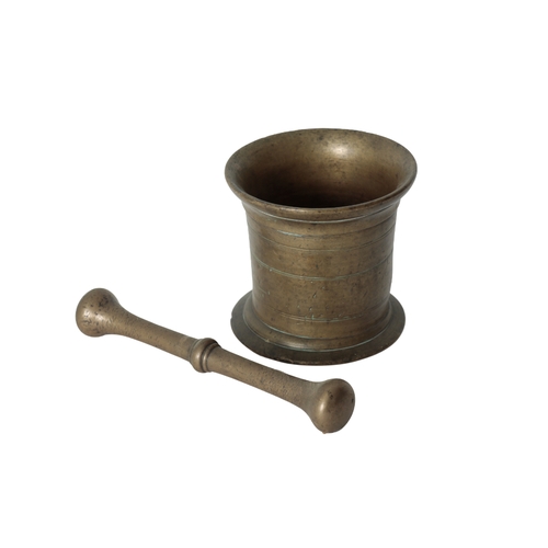 265 - AN ENGLISH 18TH CENTURY BRONZE PESTLE AND MORTAR the out turned rim above a turned body, engraved wi... 