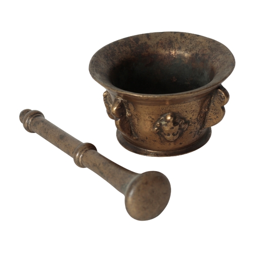 275 - A MID 17TH CENTURY BRONZE PESTLE AND MORTAR the flared rim over a body moulded with four handles and... 