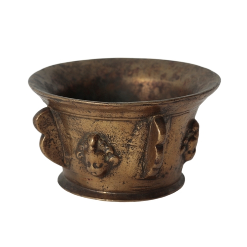 275 - A MID 17TH CENTURY BRONZE PESTLE AND MORTAR the flared rim over a body moulded with four handles and... 