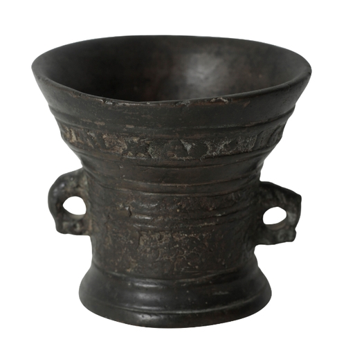 279 - A BRONZE MORTAR DATED '1603' 17th century, with flared top rim, over a turned and cast body, with tw... 