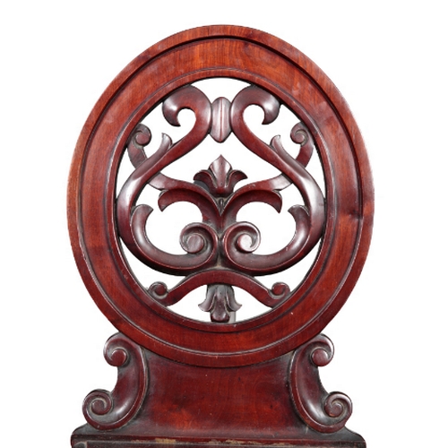 293 - A VICTORIAN MAHOGANY HALL CHAIR with oval leaf carved and pierced back, shaped seat on cabriole fron... 