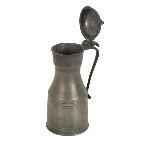 299 - AN ENGLISH PEWTER TANKARD 18th century, the lid with a turned finial, above a turned body engraved w... 