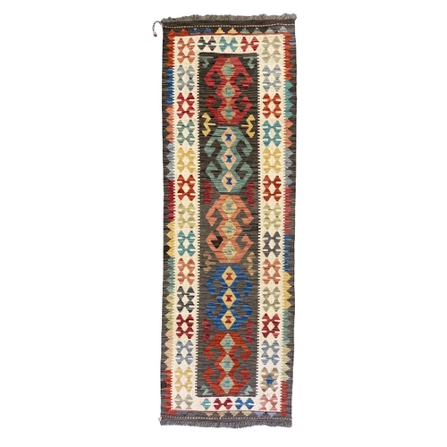 433 - AN ANATOLIAN STYLE KILIM woven in colours with hooked lozenge pole medallion, 290cm x 75cm