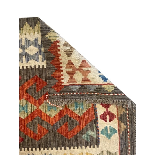 433 - AN ANATOLIAN STYLE KILIM woven in colours with hooked lozenge pole medallion, 290cm x 75cm