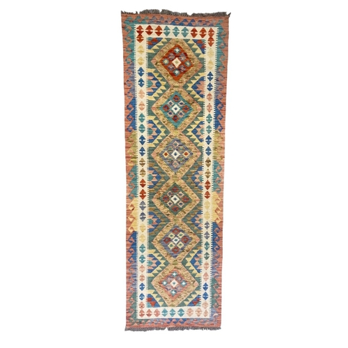 439 - AN ANATOLIAN STYLE KILIM woven in colours with hooked six pole medallion, 255cm x 82cm