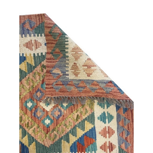 439 - AN ANATOLIAN STYLE KILIM woven in colours with hooked six pole medallion, 255cm x 82cm