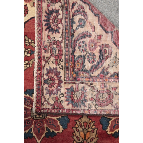 163 - A CENTRAL PERSIAN BAKHTIAR KELLEH SIZE CARPET woven in blue, turquoise and tan with floral medallion... 