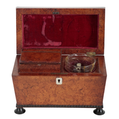 179 - A REGENCY BURR WALNUT AND EBONISED TEA CADDY early 19th century, of sarcophagus form, the hinged lid... 