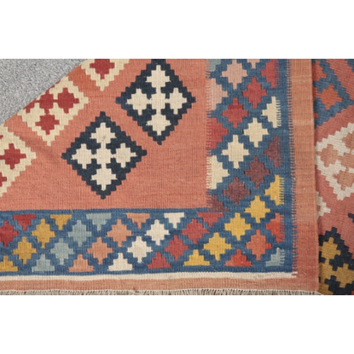 184 - A SOUTH WEST PERSIAN QASHGAI KILIM woven in colours with diagonal rows of lozenges, on an ochre grou... 