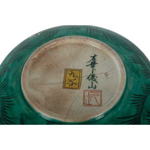 203 - AN EARLY 20TH SATSUMA POTTERY BOWL decorated to the centre with a family reading, within chrysanthem... 