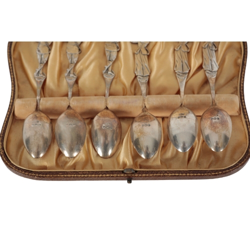 38 - A CASED SET OF SIX SILVER GOLFING TEASPOONS the terminals modelled as male and female golfers, Henry... 