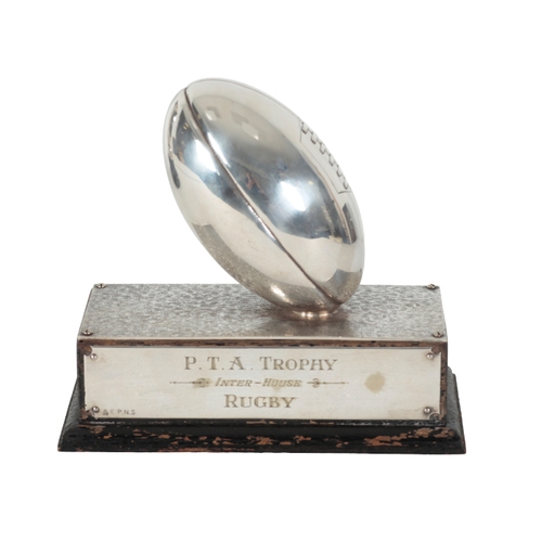 42 - A SILVER PLATED RUGBY TROPHY P.T.A. Inter-House Rugby trophy, modelled as a ball on a rectangular ba... 