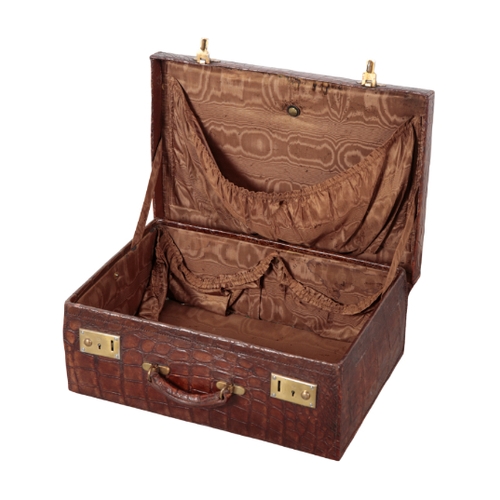 46 - AN EDWARDIAN CROCODILE SUITCASE with brown silk lining, brass locks and embossed initials to the lid... 