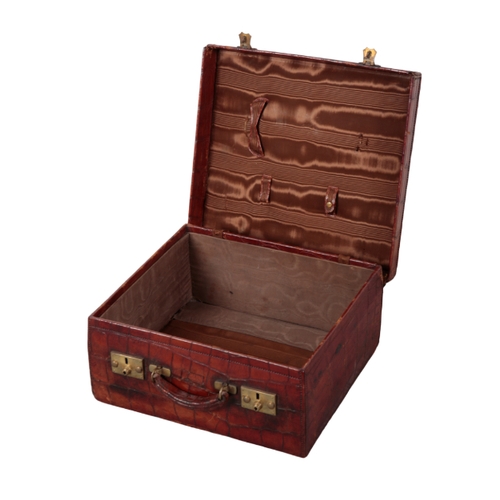 51 - ASPREY OF LONDON: AN EDWARDIAN CROCODILE VANITY CASE with brass lock fittings and dark brown silk li... 