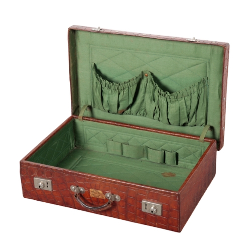 53 - AN EDWARDIAN CROCODILE TRAVEL CASE with white metal studs to the base and lid, the lid with an attac... 