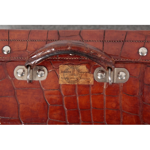 53 - AN EDWARDIAN CROCODILE TRAVEL CASE with white metal studs to the base and lid, the lid with an attac... 