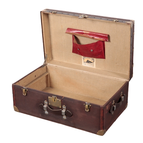 58 - MOYNAT OF PARIS: A BROWN CANVAS, WOOD AND LEATHER-BOUND TRUNK with brass corners, leather carrying h... 