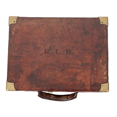 62 - A LEATHER CARTRIDGE CASE with brass bound corners, the lid initialled 