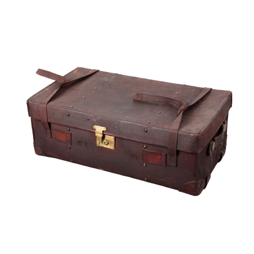 66 - AN EDWARDIAN CONTINENTAL BURGUNDY CANVAS TRAVELLING TRUNK with brass carrying handles and locks, 44c... 