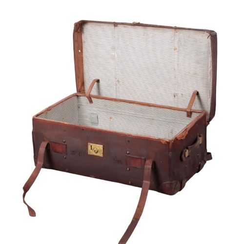 66 - AN EDWARDIAN CONTINENTAL BURGUNDY CANVAS TRAVELLING TRUNK with brass carrying handles and locks, 44c... 