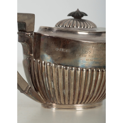 7 - AN EDWARDIAN SILVER TEAPOT BY MARTIN, HALL & CO. Sheffield, 1904, engraved to one side with a messag... 