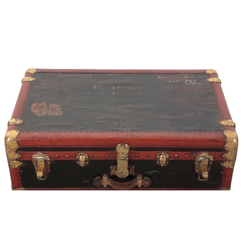 74 - A FRENCH VELLUM BRASS AND WOOD-BOUND TRUNK early 20th century, with brass locks and leather carrying... 