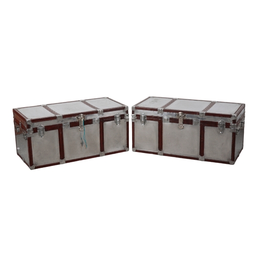 78 - A PAIR OF ALUMINIUM AND LEATHER-BOUND TRUNKS with nickel-plated locks, nickel-plated carrying handle... 