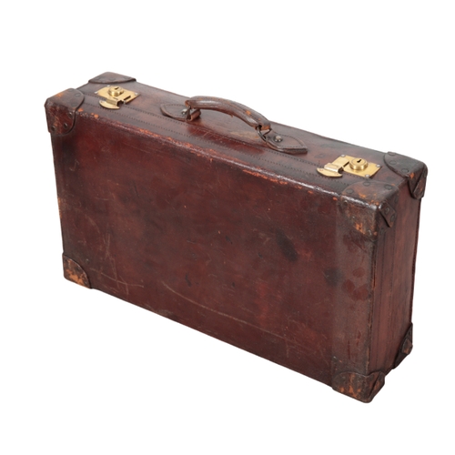 81 - A TAN LEATHER SUITCASE the brass catches inscribed 