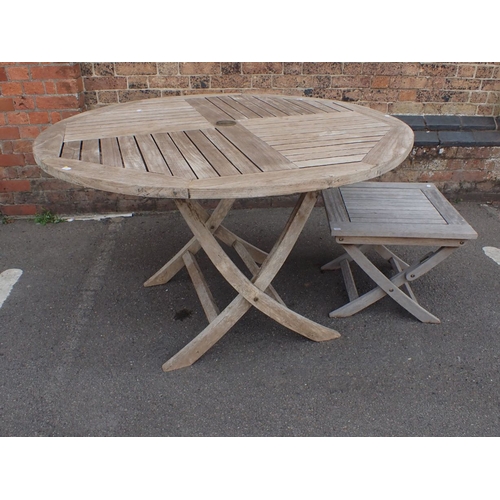 2 - A WEATHERED TEAK CIRCULAR GARDEN TABLE with hole for parasol, the top 120cm diameter, and a similar ... 