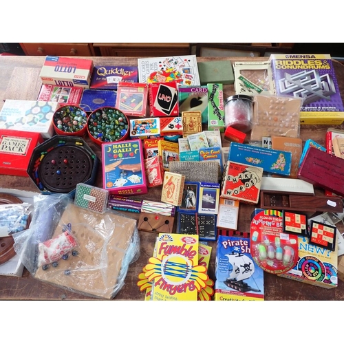 178 - TINS OF MARBLES, A BAKELITE SOLITAIRE BOARD and sundry games and toys