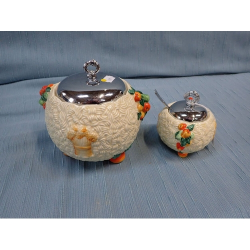 270 - CLARICE CLIFF: A NEWPORT POTTERY 'CELTIC HARVEST' JAM POT and biscuit jar, both with chrome lids (2)