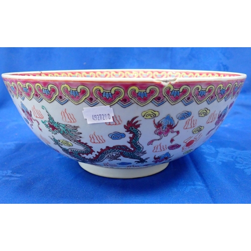 331 - A CHINESE ENAMEL DECORATED BOWL with dragons amongst clouds, 28cm diameter