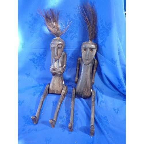 363 - TWO TRIBAL CARVED AND JOINTED WOODEN FIGURES male and female, with moveable limbs 55cm high (plus ha... 