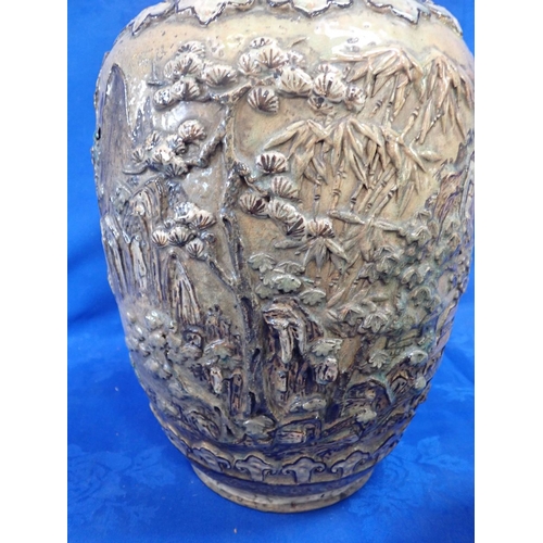 378 - A LARGE ASIAN POTTERY VASE worked in relief with landscapes, within lobed borders 43cm high (cracked... 