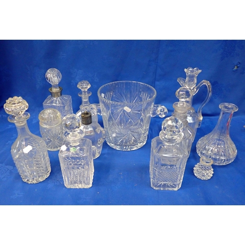 73 - A LARGE CUT GLASS ICE BUCKET AND A COLLECTION OF DECANTERS some Stuart (not all stoppers matching)