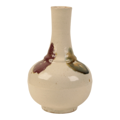 109 - A CHINESE CREAM GLAZED POTTERY BOTTLE VASE probably Qing, decorated with three coloured splashes, im... 