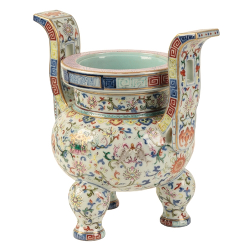 111 - A FINE CHINESE FAMILLE ROSE TRIPOD INCENSE BURNER Qing or later, enamelled in polychrome with Buddhi... 