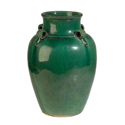 112 - A GUANGDON GREEN GLAZED POTTERY VASE Qing or later, with four ribbed lug handles, 26cm