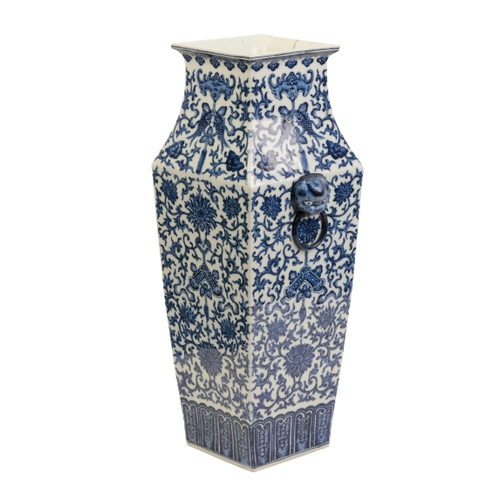 114 - A CHINESE BLUE AND WHITE VASE Qing or later, of tapering square form with lion mask and ring handles... 