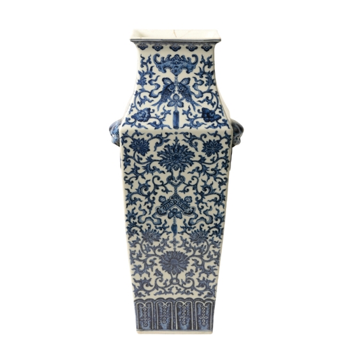 114 - A CHINESE BLUE AND WHITE VASE Qing or later, of tapering square form with lion mask and ring handles... 