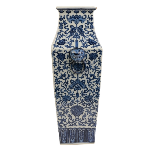 114 - A CHINESE BLUE AND WHITE VASE Qing or later, of tapering square form with lion mask and ring handles... 