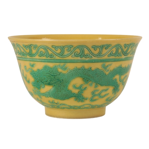 115 - A CHINESE YELLOW-GROUND GREEN ENAMLLED 'DRAGON' BOWL Qing or later, the dragons contesting flaming p... 