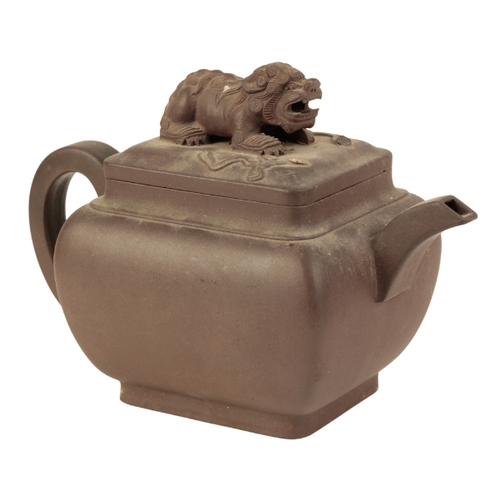 117 - A CHINESE YIXING TEAPOT of rounded rectangular form, with a curved spout and a simple loop handle, t... 