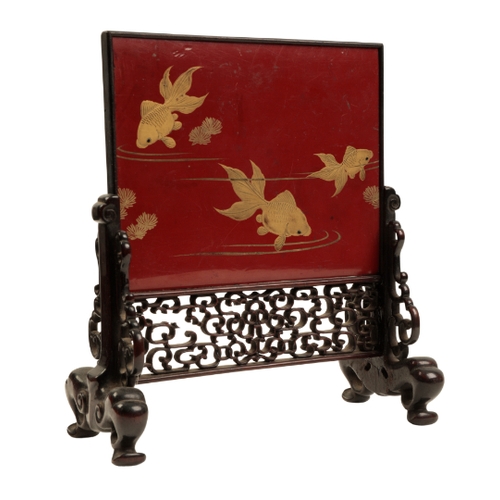 126 - A JAPANESE RED AND BLACK LACQUER TABLE SCREEN Meiji, decorated in gilt with ornamental carp, 22cm hi... 